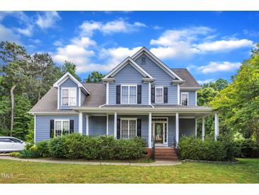 Charming two-story home featuring a welcoming front porch and beautifully manicured landscaping at 4516 Ocean Crest Cir, Raleigh, NC 27603