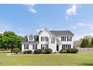 Charming two-story home with a well-manicured lawn and inviting curb appeal at 5745 Spence Farm Rd, Holly Springs, NC 27540