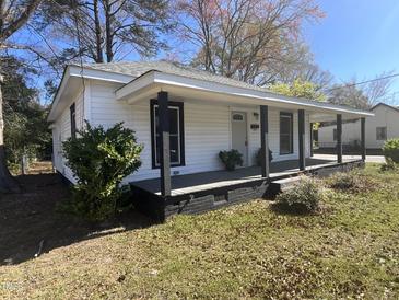 Charming single-story home featuring a welcoming front porch with dark columns and a well-maintained front yard at 602 Dexter St, Rocky Mount, NC 27803