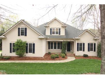 Charming two-story home with a landscaped yard, walkway and traditional architectural details including dormer windows at 85 Christenbury Ln, Clayton, NC 27527