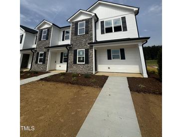 Two-story townhouse with stone accents and black shutters at 1101 Brookrun Dr, Oxford, NC 27565