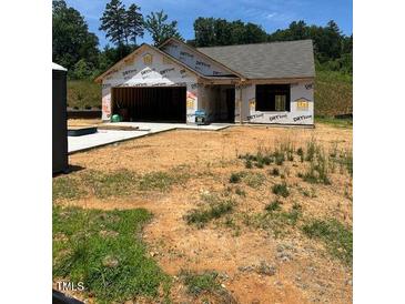 Image of home under construction showing framing, and the garage on a sunny day at 12 Crow Field St, Roxboro, NC 27574