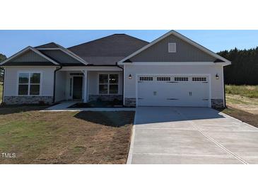 Charming home with white siding, stone accents, two-car garage and a well-manicured lawn at 1547 Pecan Drive # 31, Nashville, NC 27856