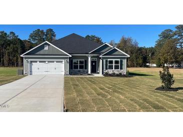 Charming single-story home boasts stone accents, a two-car garage, and a well-manicured front lawn at 1565 Pecan Drive # 30, Nashville, NC 27856