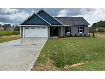 Charming single-story home featuring a two-car garage and well-maintained lawn at 161 Jones Creek Ln, Lillington, NC 27546