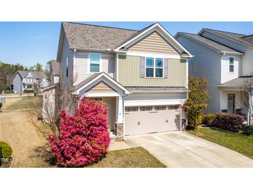 Charming two-story home featuring a 2-car garage and a beautiful pink flowering bush in the front yard at 36 Labradoodle Ct, Garner, NC 27529