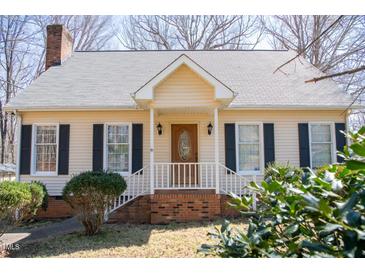 Charming single-story home featuring a front porch and meticulously maintained landscaping at 401 Joyce Rd, Hillsborough, NC 27278