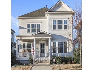 Charming two-story home with a covered front porch, large windows, and manicured landscaping at 416 Holding Creek Dr, Wake Forest, NC 27587