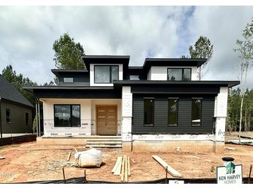 Modern home featuring a striking black and white exterior with contemporary architectural design at 95 Cherry Bark Dr, Youngsville, NC 27596