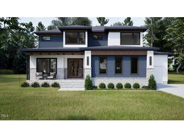 Beautiful home with blue and white color scheme, lush lawn, attractive stone accents and modern design at 95 Cherry Bark Dr, Youngsville, NC 27596