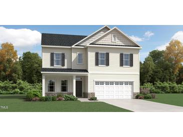 Charming two-story home with a symmetrical facade, attached garage, and well-maintained landscaping at 1505 Bright Coral Trl, Wendell, NC 27591
