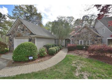 Charming stone and siding home with a well-manicured lawn and lovely landscaping at 29 Mocking Ln, Rocky Mount, NC 27804