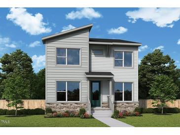 Charming two-story home with stone accents, a modern design, and well-manicured landscaping at 307 Parkland Dr, Pittsboro, NC 27312