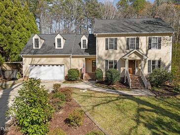 Traditional two-story home with a two-car garage, dormer windows and a well manicured lawn at 5122 Berkeley St, Raleigh, NC 27612