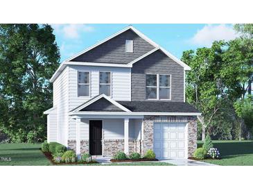 Charming two-story home featuring a mix of siding and stone, a covered porch, and an attached garage in a landscaped setting at 6037 Sodium St, Raleigh, NC 27610