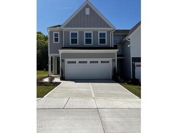 A charming gray two-story home with a large driveway and attached two-car garage at 628 Brittany Ct, Durham, NC 27703