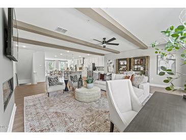 Open-concept living room featuring beamed ceilings, modern furniture, and hardwood floors at 1245 S Blount Street # 201, Raleigh, NC 27601