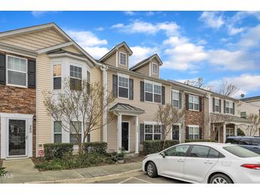Charming townhome featuring beige siding, black shutters, and stone accents for added curb appeal at 1304 Cozart St # 258, Durham, NC 27704