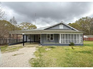 Charming single-story home with a covered carport and screened porch at 1324 Buffalo Rd, Smithfield, NC 27577