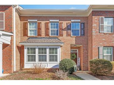 Brick townhome with brown shutters, bay window, and a welcoming front entrance with a wreath decor at 2728 Cloud Mist Cir, Raleigh, NC 27614
