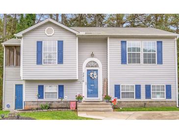 Charming home featuring blue shutters, a welcoming front door, and manicured landscaping at 2816 Delco Ct, Raleigh, NC 27610