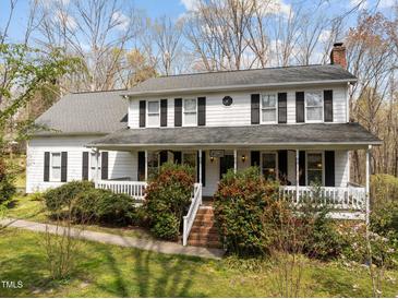 Charming two-story home with a welcoming front porch and well-maintained landscaping at 323 E Stratford Dr, Henderson, NC 27537