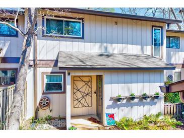 Charming front entrance of this townhome is accentuated with flower boxes and artistic touches at 3923 Wendy Ln, Raleigh, NC 27606