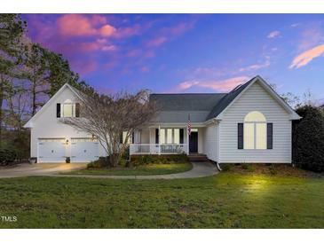 Charming home with a welcoming front porch and well-manicured lawn, perfect for outdoor relaxation at 402 Womble Dr, Lillington, NC 27546