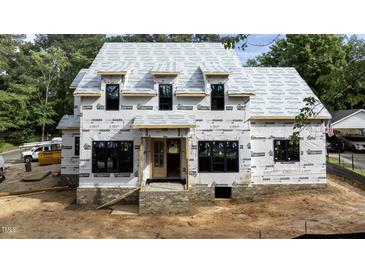 New construction home featuring a modern design with large windows and brick foundation is being built at 5107 Hearth Dr, Raleigh, NC 27609