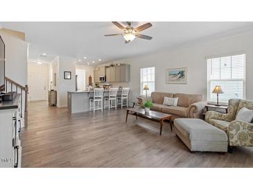 Spacious living room featuring an open-concept kitchen and natural light at 5205 Sorrell Glen Dr, Raleigh, NC 27603