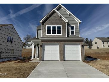 New two-story home with a two-car garage and a concrete driveway at 75 Furley St., Homesite 115, Sanford, NC 27330