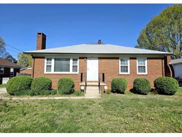 Charming brick home featuring a classic design, well-maintained landscaping, and a welcoming entrance at 807 Everett St, Burlington, NC 27215