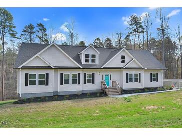 Charming single Gathering home featuring light siding, black shutters, dormer windows, and a bright blue front door at 90 Ferncrest Ct, Roxboro, NC 27574