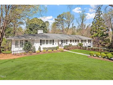 Charming ranch home with a well-manicured lawn and mature trees, providing excellent curb appeal at 1417 Hathaway Rd, Raleigh, NC 27608