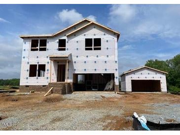 Exterior view of the new home with 2-car garage, showing the front entrance and architectural details at 15 Atherton Circle, Angier, NC 27501