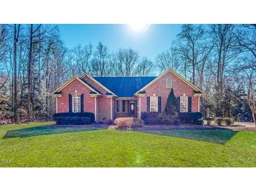 Charming single-story brick home with a well-manicured lawn and mature landscaping at 2440 Helena Moriah Rd, Timberlake, NC 27583