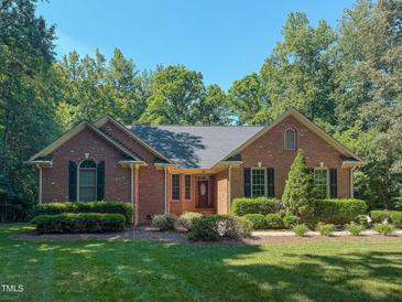 Charming brick home with manicured landscaping and mature trees at 2440 Helena Moriah Rd, Timberlake, NC 27583