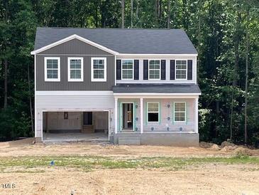 Two-story home with a gray roof, vinyl siding, an attached garage, and a covered front porch under construction at 46 Atherton Circle, Angier, NC 27501