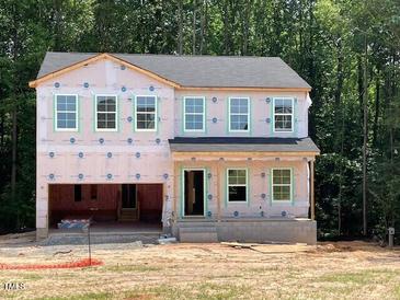 Two-story home featuring multiple windows ready for siding and other exterior finishes at 46 Atherton Circle, Angier, NC 27501