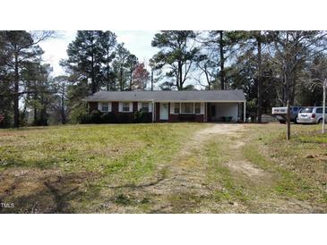 Charming single-story brick home with white trim, a spacious yard, and a private driveway at 640 Sunnybrook Rd, Raleigh, NC 27610