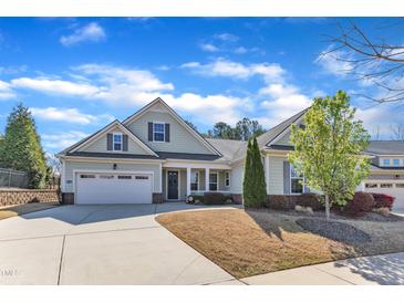 Charming single-story home with an attached two-car garage, a well-manicured lawn, and inviting curb appeal at 1038 Branwell Dr, Durham, NC 27703