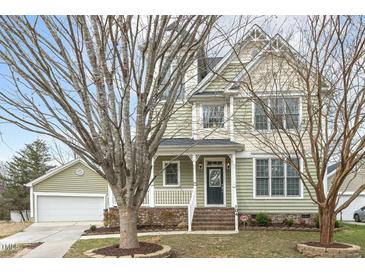Charming two-story home with manicured lawn, welcoming porch, and attached two-car garage at 104 Low Country Ct, Morrisville, NC 27560