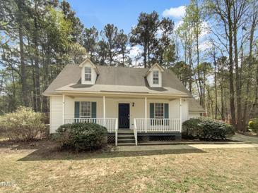 Charming single-story home featuring a welcoming front porch and dormer windows at 129 Bridges Ln, Youngsville, NC 27596