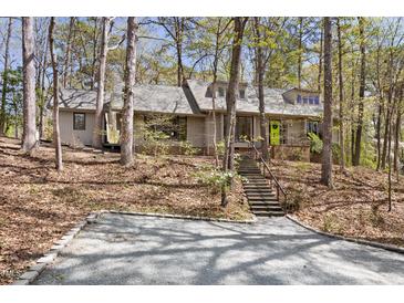 Charming home nestled in a wooded lot with a bright green front door, offering a serene and private setting at 1516 Cumberland Rd, Chapel Hill, NC 27514