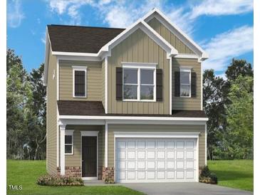 Charming two-story home featuring a two-car garage and neutral-colored exterior at 176 Bruce Dr, Dunn, NC 28334