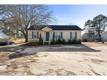 Charming one-story home with a cozy front porch and landscaped yard at 227 Coley Farm Rd, Fuquay Varina, NC 27526
