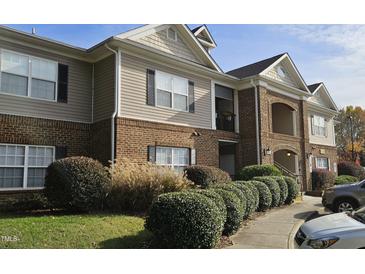 Inviting exterior of a brick and siding multi-Gathering home with manicured landscaping and a private balcony at 2631 Oldgate Dr # 101, Raleigh, NC 27604