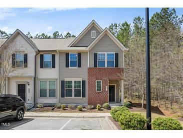 Charming two-story townhouse with brick accents and well-manicured landscaping at 30 Holly Berry Ln, Durham, NC 27703