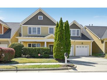Charming two-story home with well-manicured lawn and attached two car garage at 304 Frontgate Dr, Cary, NC 27519