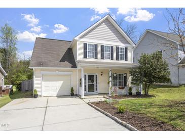 Charming two-story home with a manicured lawn, attached garage, and inviting front porch at 3905 Joe And Ruth Lee Dr, Raleigh, NC 27610